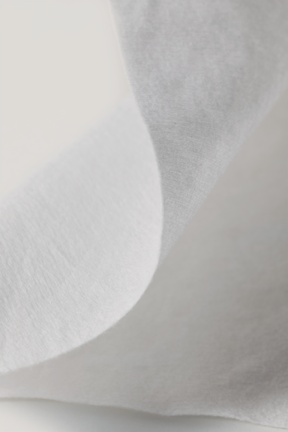 Close-up of a l'Essentiel cotton tissue texture with a light gray background